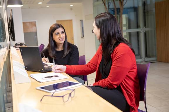 Two work colleagues in a meeting.