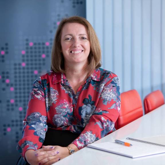 Elaine Morrison, Director Business Partnerships at Scottish Enterprise sitting at a desk. 